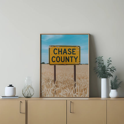 Yellow "Chase County" sign in a golden wheat field.