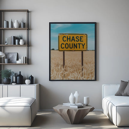 Yellow "Chase County" sign in a framed picture above a couch.
