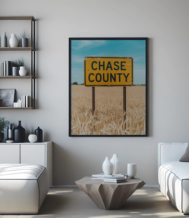 Yellow "Chase County" sign in a framed picture above a couch.