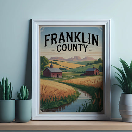 Framed artwork depicting a rural landscape with a barn, wheat fields, and rolling hills.