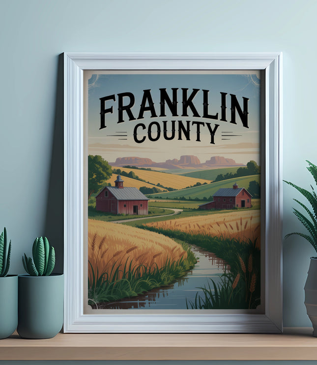 Framed artwork depicting a rural landscape with a barn, wheat fields, and rolling hills.