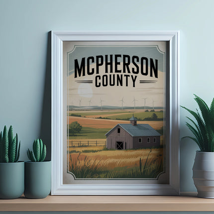 Framed poster of McPherson County with barn and windmills, displayed on a shelf.