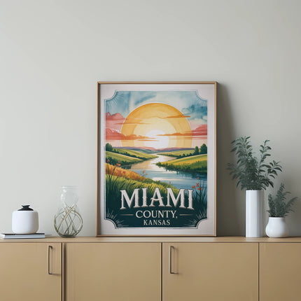 Framed vintage travel poster for Miami County, Kansas featuring a sunset over a river.