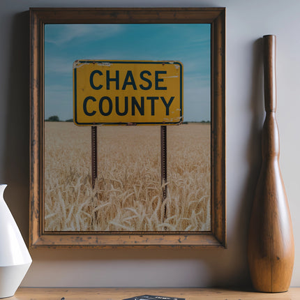 Framed artwork shows a Chase County sign in a golden wheat field.